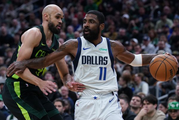 Feb 6, 2025; Boston, Massachusetts, USA; Dallas Mavericks guard Kyrie Irving (11) drives the ball against Boston Celtics guard Derrick White (9) in the first quarter at TD Garden. Mandatory Credit: David Butler II-Imagn Images