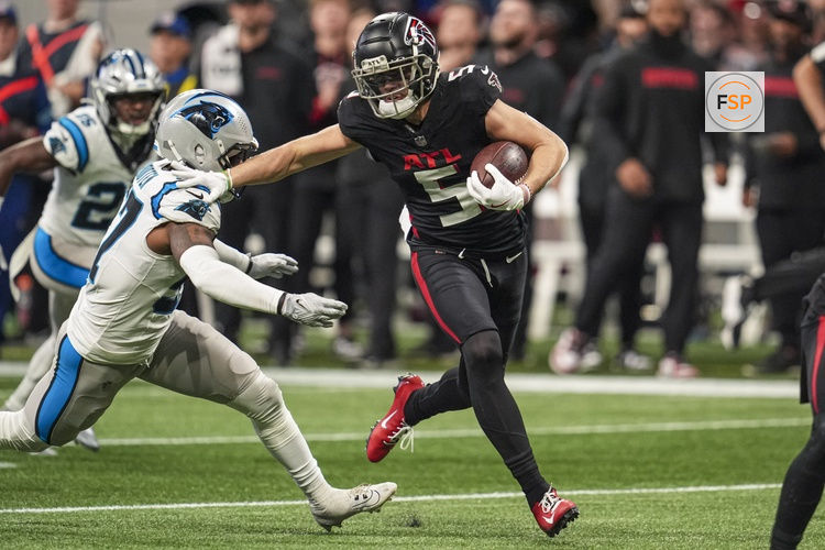 Jan 5, 2025; Atlanta, Georgia, USA; Atlanta Falcons wide receiver Drake London (5) runs against Carolina Panthers linebacker Chandler Wooten (57) after a catch during the first half at Mercedes-Benz Stadium. Credit: Dale Zanine-Imagn Images