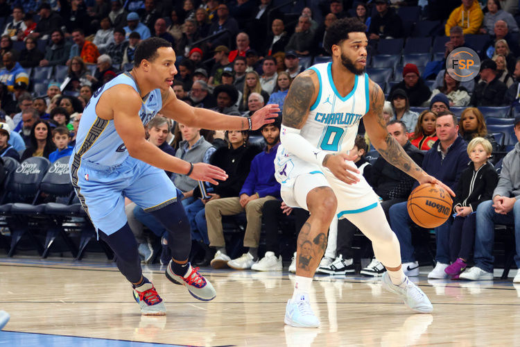 Jan 22, 2025; Memphis, Tennessee, USA; Charlotte Hornets forward Miles Bridges (0) dribbles as Memphis Grizzlies guard Desmond Bane (22) defends during the first quarter at FedExForum. Credit: Petre Thomas-Imagn Images