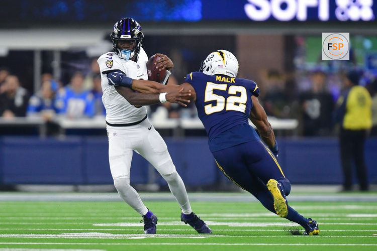 Nov 25, 2024; Inglewood, California, USA; Baltimore Ravens quarterback Lamar Jackson (8) runs the ball against Los Angeles Chargers linebacker Khalil Mack (52) during the second half at SoFi Stadium. Credit: Gary A. Vasquez-Imagn Images