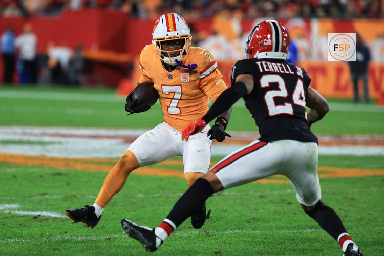 Dec 11, 2025; Tampa, Florida, USA; Tampa Bay Buccaneers running back Bucky Irving (7) runs the ball against Atlanta Falcons cornerback A.J. Terrell Jr. (24) during the second quarter at Raymond James Stadium. Credit: Kim Klement Neitzel-Imagn Images