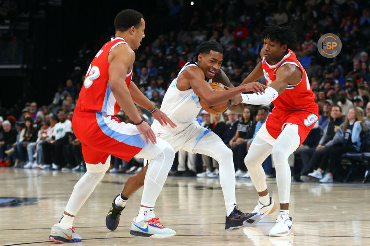 Jan 20, 2025; Memphis, Tennessee, USA; Minnesota Timberwolves guard Rob Dillingham (4) drives to the basket between Memphis Grizzlies guard Desmond Bane (22) and forward GG Jackson II (45) during the fourth quarter at FedExForum. Credit: Petre Thomas-Imagn Images