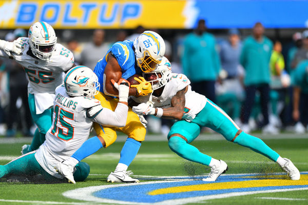 INGLEWOOD, CA - SEPTEMBER 10: Los Angeles Chargers running back Joshua Kelley (25) is hit by Miami Dolphins linebacker Jaelan Phillips (15) and Miami Dolphins safety DeShon Elliott (21) during the NFL regular season game between the Miami Dolphins and the Los Angeles Chargers on September 10, 2023, at SoFi Stadium in Inglewood, CA. (Photo by Brian Rothmuller/Icon Sportswire)