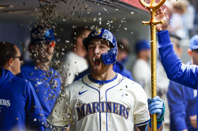 Jun 16, 2024; Seattle, Washington, USA; Seattle Mariners first baseman Tyler Locklear (27) celebrates in the dugout with after hitting a solo-home run against the Texas Rangers during the seventh inning at T-Mobile Park. Mandatory Credit: Joe Nicholson-USA TODAY Sports