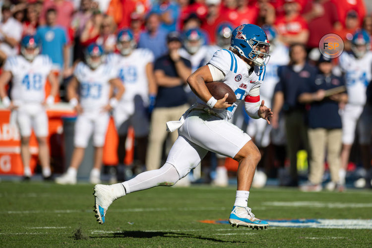 Nov 23, 2024; Gainesville, Florida, USA; Mississippi Rebels quarterback Jaxson Dart (2) rushes with the ball against the Florida Gators during the second half at Ben Hill Griffin Stadium. Credit: Matt Pendleton-Imagn Images