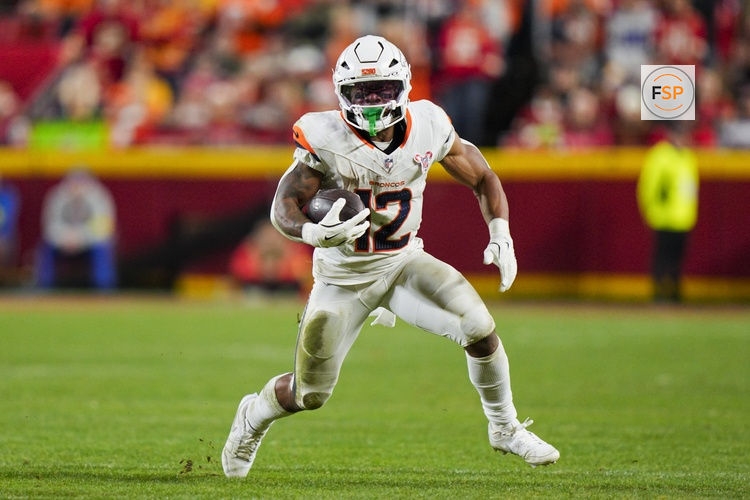 Dec 25, 2025; Kansas City, Missouri, USA; Denver Broncos running back RJ Harvey (12) runs with the ball during the second half against the Kansas City Chiefs at GEHA Field at Arrowhead Stadium. Credit: Jay Biggerstaff-Imagn Images