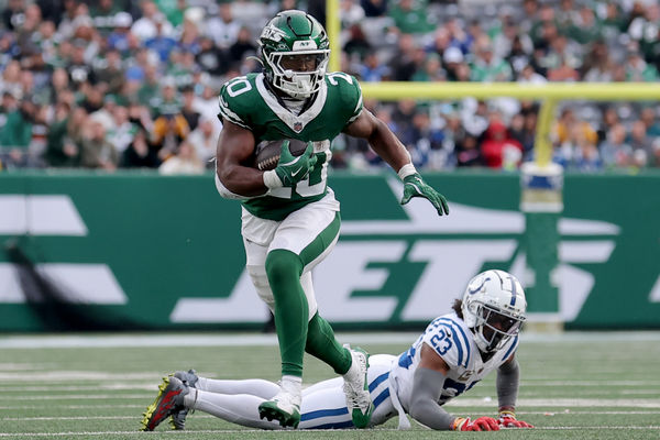 Nov 17, 2024; East Rutherford, New Jersey, USA; New York Jets running back Breece Hall (20) runs with the ball against Indianapolis Colts cornerback Kenny Moore II (23) during the fourth quarter at MetLife Stadium. Mandatory Credit: Brad Penner-Imagn Images