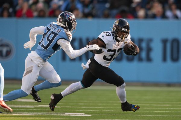 Nov 30, 2025; Nashville, Tennessee, USA;  Jacksonville Jaguars running back Bhayshul Tuten (33) runs with the ball against the Tennessee Titans during the second half at Nissan Stadium. Mandatory Credit: Steve Roberts-Imagn Images