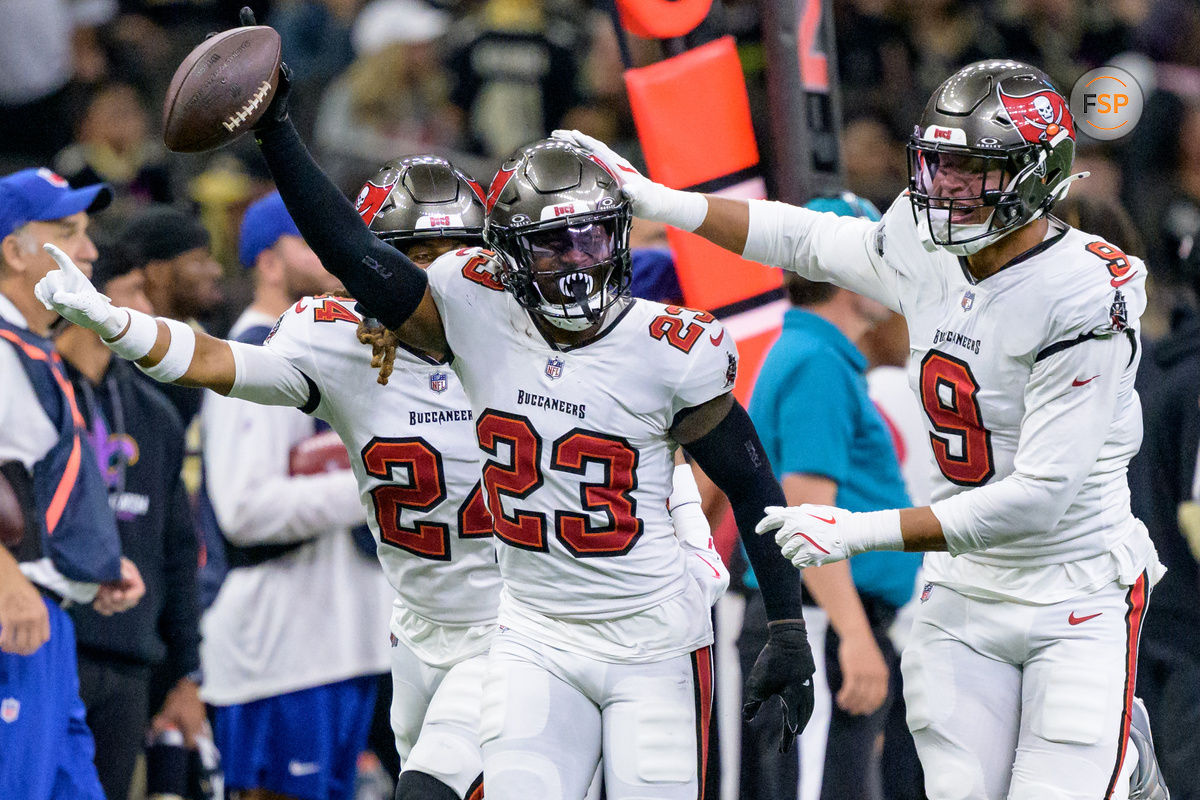 Oct 13, 2024; New Orleans, Louisiana, USA; Tampa Bay Buccaneers safety Tykee Smith (23) celebrates an interception of a ball intended for New Orleans Saints wide receiver Rashid Shaheed (22) with cornerback Tyrek Funderburk (24) and linebacker Joe Tryon-Shoyinka (9) during the fourth quarter at Caesars Superdome. Credit: Matthew Hinton-Imagn Images