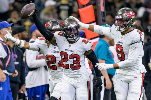 Oct 13, 2024; New Orleans, Louisiana, USA; Tampa Bay Buccaneers safety Tykee Smith (23) celebrates an interception of a ball intended for New Orleans Saints wide receiver Rashid Shaheed (22) with cornerback Tyrek Funderburk (24) and linebacker Joe Tryon-Shoyinka (9) during the fourth quarter at Caesars Superdome. Mandatory Credit: Matthew Hinton-Imagn Images