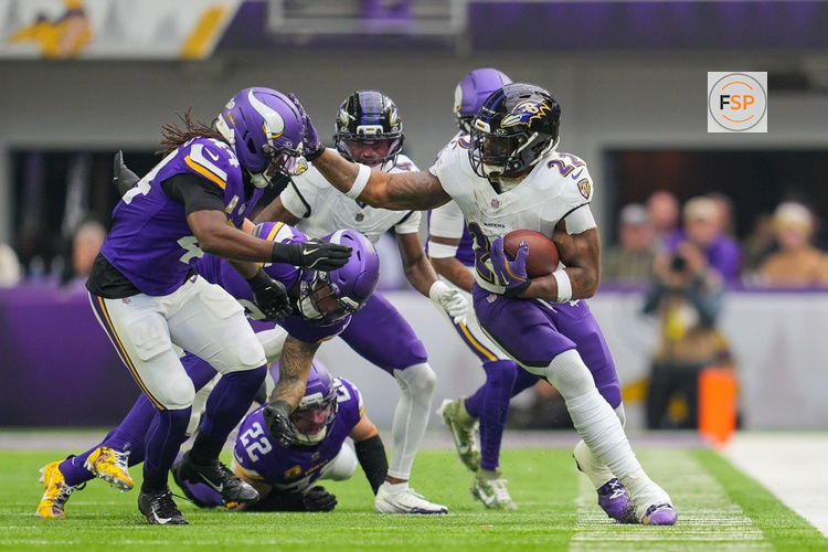Nov 9, 2025; Minneapolis, Minnesota, USA; Baltimore Ravens running back Derrick Henry (22) runs with the ball against Minnesota Vikings safety Joshua Metellus (44) in the second quarter at U.S. Bank Stadium. Credit: Brad Rempel-Imagn Images