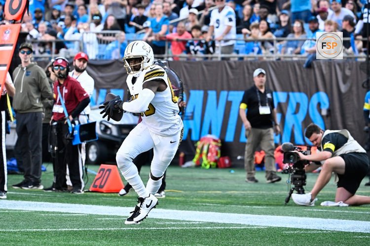 Nov 9, 2025; Charlotte, North Carolina, USA;  New Orleans Saints tight end Juwan Johnson (83) makes a catch and runs for a touchdown during the fourth quarter against the Carolina Panthers at Bank of America Stadium. Credit: Bob Donnan-Imagn Images