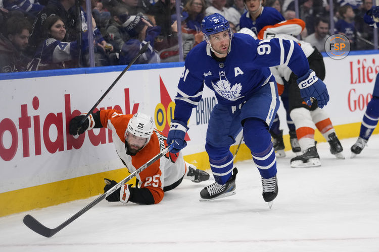 Jan 5, 2025; Toronto, Ontario, CAN; Toronto Maple Leafs forward John Tavares (91) looks for the puck after knocking down Philadelphia Flyers defenceman Rasmus Ristolainen (55) during the third period at Scotiabank Arena. Credit: John E. Sokolowski-Imagn Images