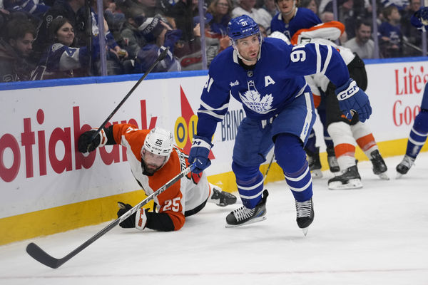 Jan 5, 2025; Toronto, Ontario, CAN; Toronto Maple Leafs forward John Tavares (91) looks for the puck after knocking down Philadelphia Flyers defenceman Rasmus Ristolainen (55) during the third period at Scotiabank Arena. Mandatory Credit: John E. Sokolowski-Imagn Images