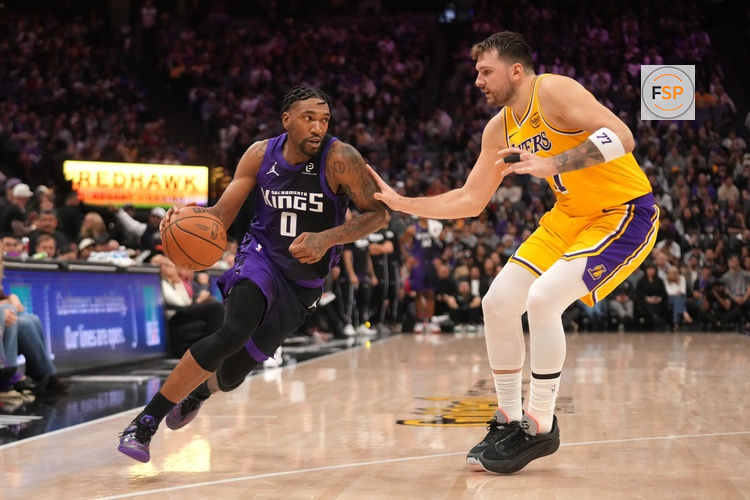Jan 12, 2026; Sacramento, California, USA; Sacramento Kings guard Malik Monk (0) dribbles the ball next to Los Angeles Lakers guard Luka Doncic (77) in the fourth quarter at the Golden 1 Center. Credit: Cary Edmondson-Imagn Images