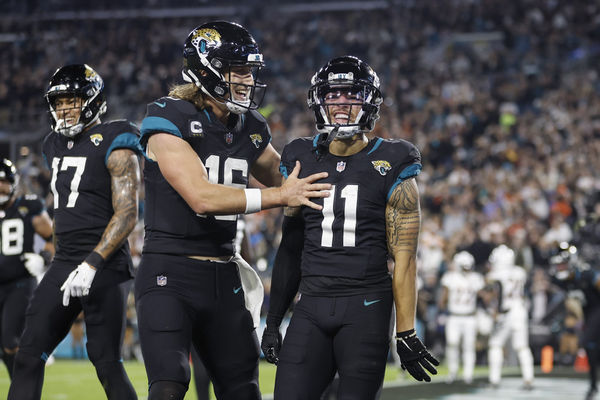 JACKSONVILLE, FL - DECEMBER 04: Jacksonville Jaguars quarterback Trevor Lawrence (16) and Jacksonville Jaguars wide receiver Parker Washington (11) celebrate a touchdown during the game between the Jacksonville Jaguars and the Cincinnati Bengals on December 4, 2023 at EverBank Stadium in Jacksonville, Fl. (Photo by David Rosenblum/Icon Sportswire)