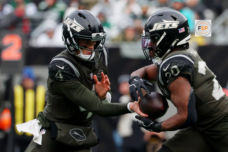 Dec 7, 2025; East Rutherford, New Jersey, USA; New York Jets quarterback Brady Cook (4) hands the ball off to running back Breece Hall (20) during the first half at MetLife Stadium. Credit: Ed Mulholland-Imagn Images