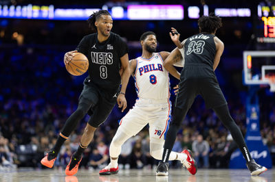 Feb 22, 2025; Philadelphia, Pennsylvania, USA; Brooklyn Nets forward Ziaire Williams (8) dribbles around Philadelphia 76ers forward Paul George (8) on the pick by center Nic Claxton (33) during the first quarter at Wells Fargo Center. Mandatory Credit: Bill Streicher-Imagn Images