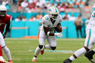 Oct 27, 2024; Miami Gardens, Florida, USA; Miami Dolphins wide receiver Tyreek Hill (10) runs with the football against the Arizona Cardinals during the first quarter at Hard Rock Stadium. Mandatory Credit: Sam Navarro-Imagn Images