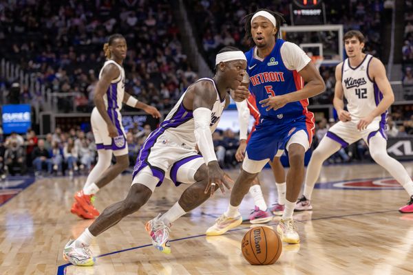 Jan 25, 2026; Detroit, Michigan, USA; Detroit Pistons forward Ronald Holland II (5) defends against Sacramento Kings guard Dennis Schroder (17) during the first half at Little Caesars Arena. Mandatory Credit: David Reginek-Imagn Images