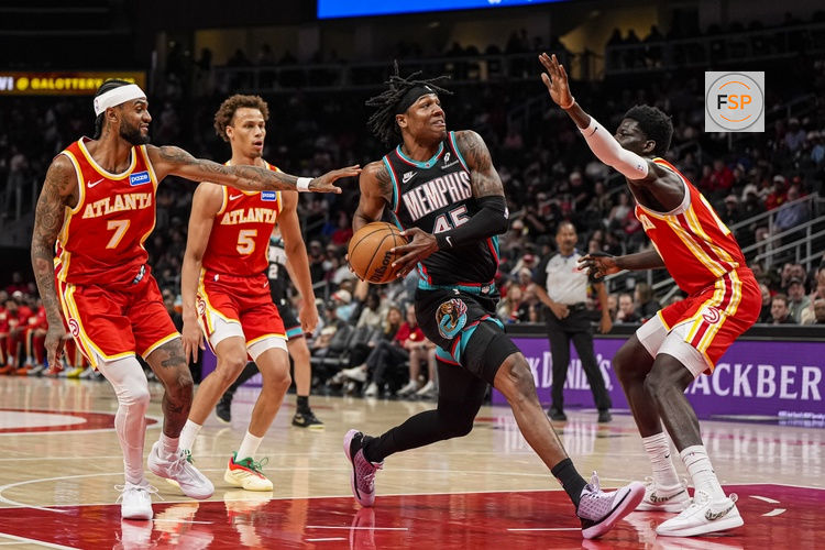 Mar 23, 2026; Atlanta, Georgia, USA; Memphis Grizzlies forward GG Jackson (45) drives to the basket against Atlanta Hawks guard Nickeil Alexander-Walker (7) and forward Mouhamed Gueye (18) during the first half at State Farm Arena. Credit: Dale Zanine-Imagn Images