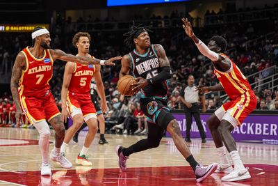 Mar 23, 2026; Atlanta, Georgia, USA; Memphis Grizzlies forward GG Jackson (45) drives to the basket against Atlanta Hawks guard Nickeil Alexander-Walker (7) and forward Mouhamed Gueye (18) during the first half at State Farm Arena. Mandatory Credit: Dale Zanine-Imagn Images
