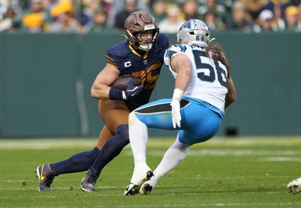 Nov 2, 2025; Green Bay, Wisconsin, USA; Green Bay Packers tight end Tucker Kraft (85) runs after a catch against Carolina Panthers linebacker Christian Rozeboom (56) during the first half at Lambeau Field. Mandatory Credit: Jeff Hanisch-Imagn Images