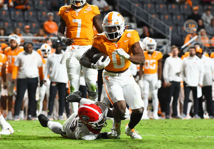 KNOXVILLE, TN - NOVEMBER 18: Tennessee Volunteers Running Back Jaylen Wright (0) rushes the ball as Georgia Bulldogs Defensive Back Tykee Smith (23) defends during the college football game between the Georgia Bulldogs and the Tennessee Volunteers on November 18, 2023, at Neyland Stadium in Knoxville, TN. (Photo by Jeffrey Vest/Icon Sportswire)