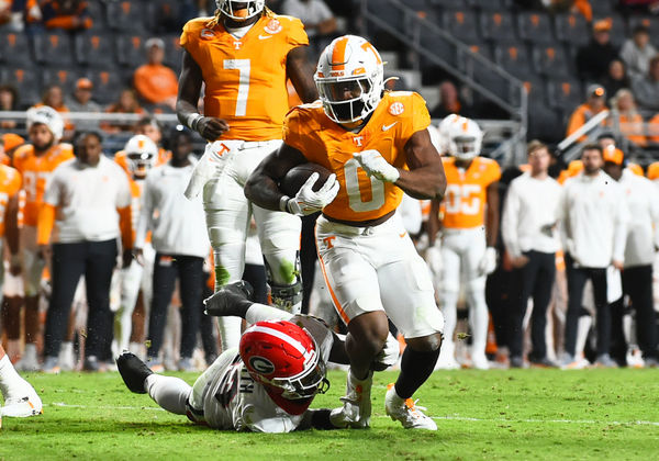 KNOXVILLE, TN - NOVEMBER 18: Tennessee Volunteers Running Back Jaylen Wright (0) rushes the ball as Georgia Bulldogs Defensive Back Tykee Smith (23) defends during the college football game between the Georgia Bulldogs and the Tennessee Volunteers on November 18, 2023, at Neyland Stadium in Knoxville, TN. (Photo by Jeffrey Vest/Icon Sportswire)