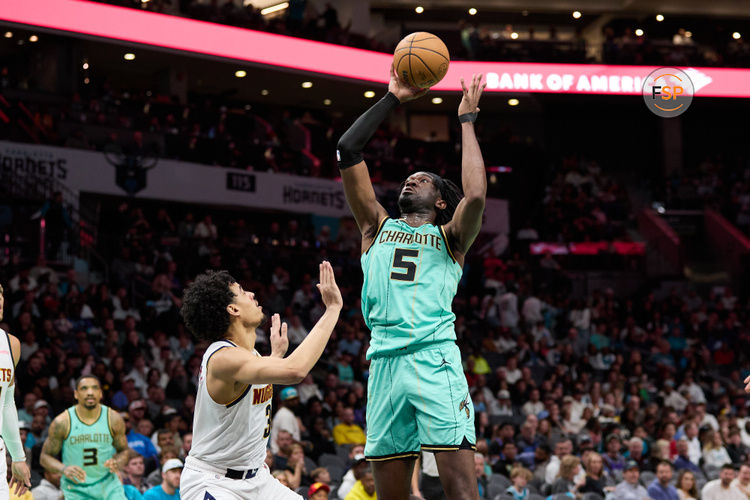 Feb 1, 2025; Charlotte, North Carolina, USA; Charlotte Hornets center Mark Williams (5) shoots over Denver Nuggets guard Julian Strawther (3) during the second half of play at Spectrum Center. Credit: Brian Westerholt-Imagn Images