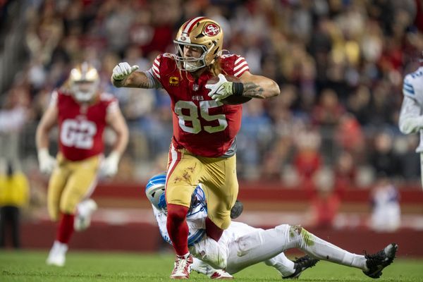 December 30, 2024; Santa Clara, California, USA; San Francisco 49ers tight end George Kittle (85) is tackled by Detroit Lions safety Ifeatu Melifonwu (6) during the fourth quarter at Levi's Stadium. Mandatory Credit: Kyle Terada-Imagn Images