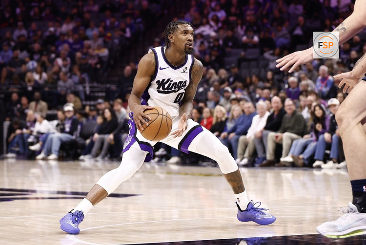 Nov 30, 2025; Sacramento, California, USA; Sacramento Kings guard Malik Monk (0) controls the ball against the Memphis Grizzlies during the fourth quarter at Golden 1 Center. Credit: Kelley L Cox-Imagn Images