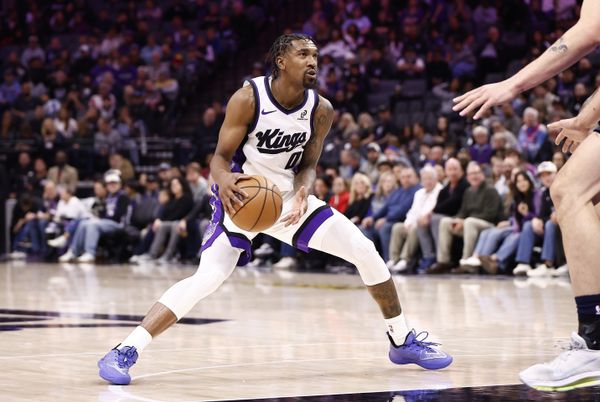 Nov 30, 2025; Sacramento, California, USA; Sacramento Kings guard Malik Monk (0) controls the ball against the Memphis Grizzlies during the fourth quarter at Golden 1 Center. Mandatory Credit: Kelley L Cox-Imagn Images