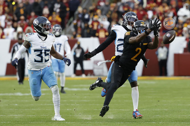 Dec 1, 2024; Landover, Maryland, USA; Washington Commanders wide receiver Dyami Brown (2) attempts to catch a pass as Tennessee Titans cornerback Daryl Worley (35) and Titans cornerback Jarvis Brownlee Jr. (29) Defend during the fourth quarter at Northwest Stadium. Credit: Geoff Burke-Imagn Images