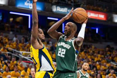 Apr 26, 2024; Indianapolis, Indiana, USA; Milwaukee Bucks forward Khris Middleton (22) shoots the ball while Indiana Pacers forward Aaron Nesmith (23) defends during game three of the first round for the 2024 NBA playoffs at Gainbridge Fieldhouse. Mandatory Credit: Trevor Ruszkowski-USA TODAY Sports