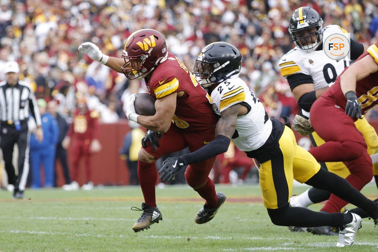 Nov 10, 2024; Landover, Maryland, USA; Washington Commanders running back Austin Ekeler (30) carries the ball as Pittsburgh Steelers linebacker Elandon Roberts (50) tackles during the first half at Northwest Stadium. Credit: Amber Searls-Imagn Images
