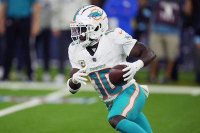 Nov 11, 2024; Inglewood, California, USA; Miami Dolphins wide receiver Tyreek Hill (10) carries the ball against the Los Angeles Rams in the second half at SoFi Stadium. Mandatory Credit: Kirby Lee-Imagn Images