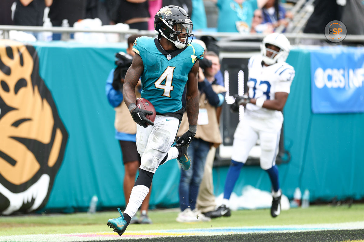 Oct 6, 2024; Jacksonville, Florida, USA; Jacksonville Jaguars running back Tank Bigsby (4) scores a touchdown against the Indianapolis Colts in the fourth quarter at EverBank Stadium. Credit: Nathan Ray Seebeck-Imagn Images