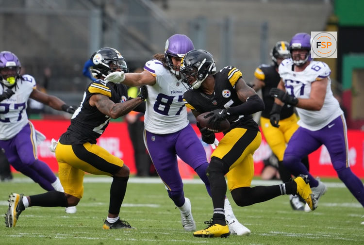 Sep 28, 2025; Dublin, Ireland; Pittsburgh Steelers safety Deshon Elliott (25) intercepts a pass thrown by Minnesota Vikings quarterback Carson Wentz (11) during the second quarter during an NFL International Series game at Croke Park. Credit: Kirby Lee-Imagn Images