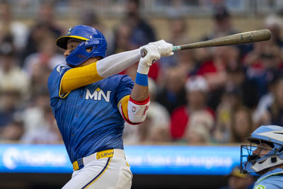 Jun 6, 2025; Minneapolis, Minnesota, USA; Minnesota Twins third baseman Royce Lewis (23) hits a double against the Toronto Blue Jays in the second inning at Target Field. Mandatory Credit: Jesse Johnson-Imagn Images