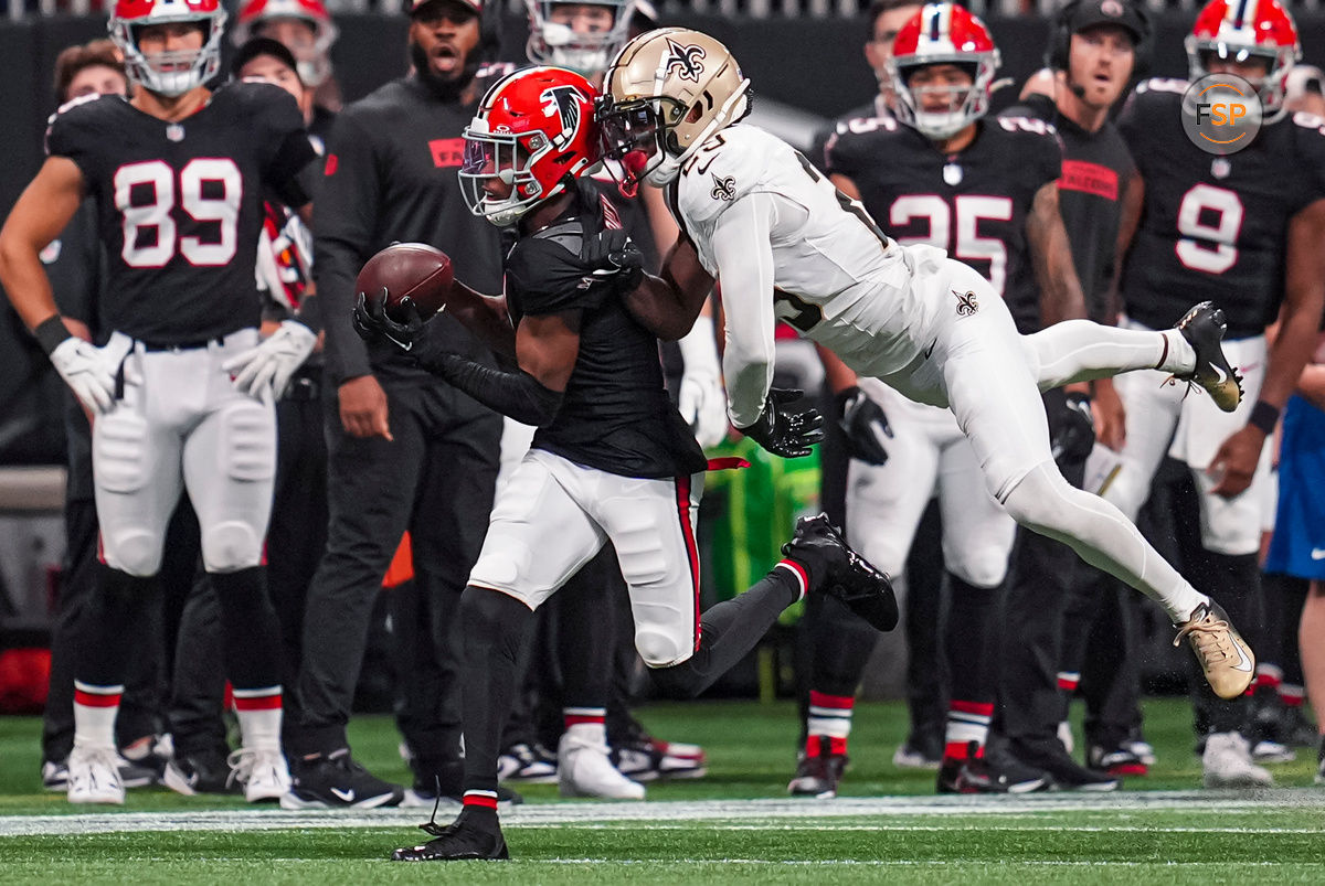 Sep 29, 2024; Atlanta, Georgia, USA; Atlanta Falcons wide receiver Darnell Mooney (1) makes a catch behind New Orleans Saints cornerback Paulson Adebo (29) at Mercedes-Benz Stadium. Credit: Dale Zanine-Imagn Images