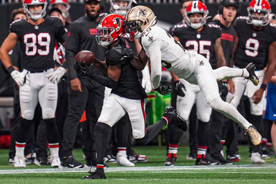 Sep 29, 2024; Atlanta, Georgia, USA; Atlanta Falcons wide receiver Darnell Mooney (1) makes a catch behind New Orleans Saints cornerback Paulson Adebo (29) at Mercedes-Benz Stadium. Mandatory Credit: Dale Zanine-Imagn Images