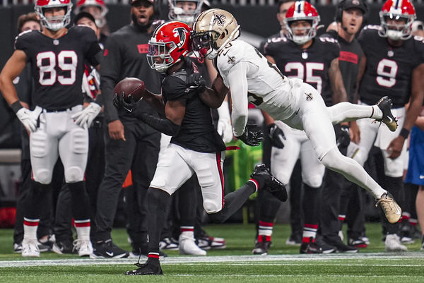 Sep 29, 2024; Atlanta, Georgia, USA; Atlanta Falcons wide receiver Darnell Mooney (1) makes a catch behind New Orleans Saints cornerback Paulson Adebo (29) at Mercedes-Benz Stadium. Mandatory Credit: Dale Zanine-Imagn Images