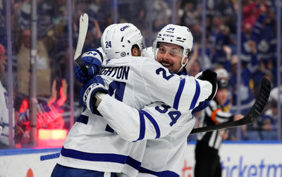 Apr 15, 2025; Buffalo, New York, USA;  Toronto Maple Leafs center Auston Matthews (34) celebrates his 400th career NHL goal on an empty net with left wing Scott Laughton (24) during the third period against the Buffalo Sabres at KeyBank Center. Mandatory Credit: Timothy T. Ludwig-Imagn Images