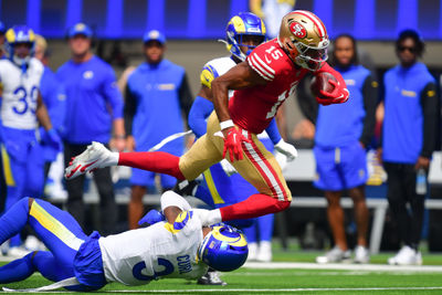 Sep 22, 2024; Inglewood, California, USA; San Francisco 49ers wide receiver Jauan Jennings (15) runs the ball against Los Angeles Rams safety Kamren Curl (3) during the first half at SoFi Stadium. Mandatory Credit: Gary A. Vasquez-Imagn Images