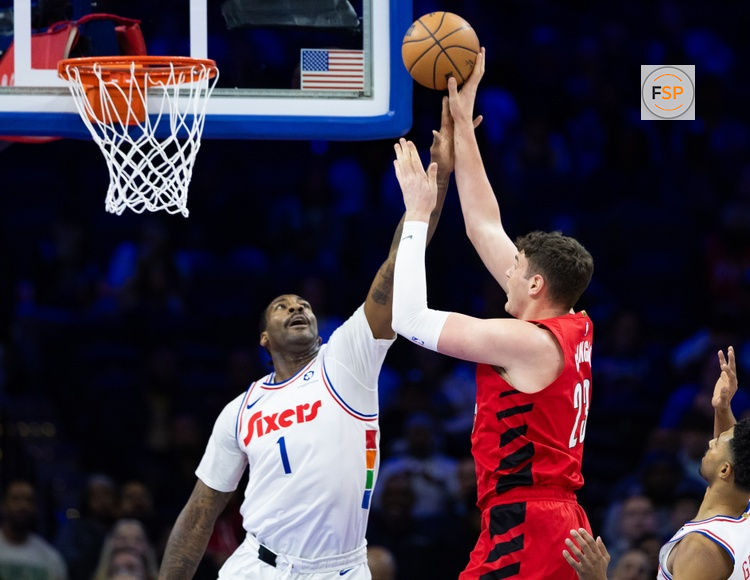 Mar 3, 2025; Philadelphia, Pennsylvania, USA; Portland Trail Blazers center Donovan Clingan (23) shoots against Philadelphia 76ers center Andre Drummond (1) during the first quarter at Wells Fargo Center. Credit: Bill Streicher-Imagn Images