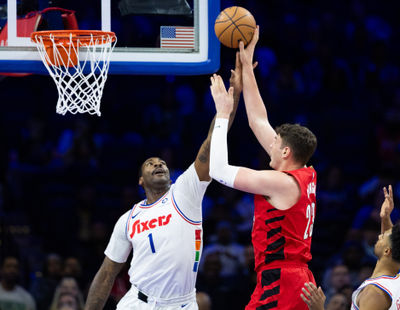 Mar 3, 2025; Philadelphia, Pennsylvania, USA; Portland Trail Blazers center Donovan Clingan (23) shoots against Philadelphia 76ers center Andre Drummond (1) during the first quarter at Wells Fargo Center. Mandatory Credit: Bill Streicher-Imagn Images