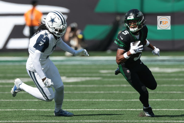 Oct 5, 2025; East Rutherford, New Jersey, USA; New York Jets wide receiver Garrett Wilson (5) turns up field after the catch as Dallas Cowboys cornerback Trevon Diggs (7) defends during the first half at MetLife Stadium. Credit: Vincent Carchietta-Imagn Images