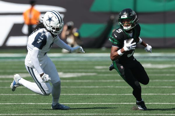 Oct 5, 2025; East Rutherford, New Jersey, USA; New York Jets wide receiver Garrett Wilson (5) turns up field after the catch as Dallas Cowboys cornerback Trevon Diggs (7) defends during the first half at MetLife Stadium. Mandatory Credit: Vincent Carchietta-Imagn Images