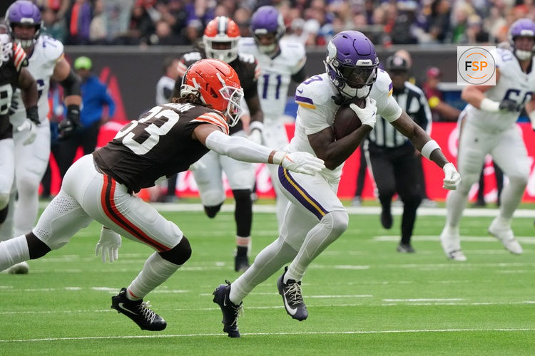Oct 5, 2025; Tottenham, United Kingdom; Minnesota Vikings wide receiver Jordan Addison (3) runs with the ball against Cleveland Browns safety Ronnie Hickman Jr. (33) during the third quarter of an NFL International Series game at Tottenham Hotspur Stadium. Credit: Kirby Lee-Imagn Images